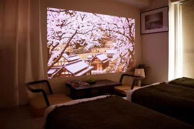 a room with two beds and a window with a picture of a tree at renovated in June 2025 apartment 3mins walk to station 1stop to Shinjuku 3stop to Shibuya in Tokyo