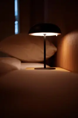 a lamp sitting on a table next to a couch at renovated in June 2025 apartment 3mins walk to station 1stop to Shinjuku 3stop to Shibuya in Tokyo