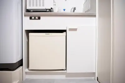 a white kitchen with a sink and a dishwasher at renovated in June 2025 apartment 3mins walk to station 1stop to Shinjuku 3stop to Shibuya in Tokyo