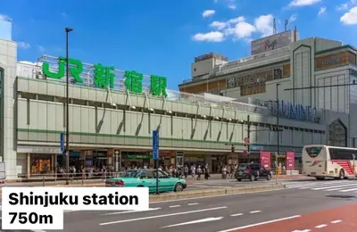 a city street with cars parked in front of a building at renovated in June 2025 apartment 3mins walk to station 1stop to Shinjuku 3stop to Shibuya in Tokyo