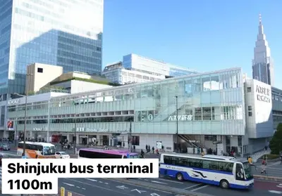 a bus is parked in front of a building at renovated in June 2025 apartment 3mins walk to station 1stop to Shinjuku 3stop to Shibuya in Tokyo