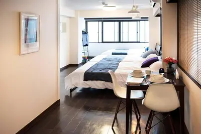 a bedroom with a bed and a table and chairs at ③2station to Shinjuku. 3 double beds. Specious 45㎡ in Tokyo