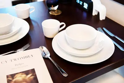 a table with white cups and saucers on it at ③2station to Shinjuku. 3 double beds. Specious 45㎡ in Tokyo