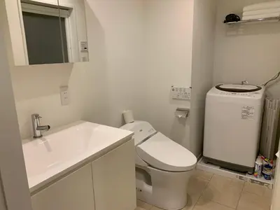 a white bathroom with a toilet and a sink at SALON\u6e0b\u8c374A in Tokyo