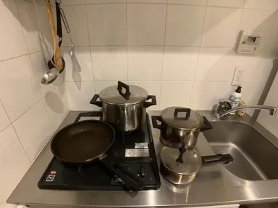 two pots and pans sitting on top of a stove at SALON\u6e0b\u8c374A in Tokyo