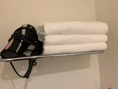 a towel rack with towels and a snowboard on it at SALON\u6e0b\u8c374A in Tokyo