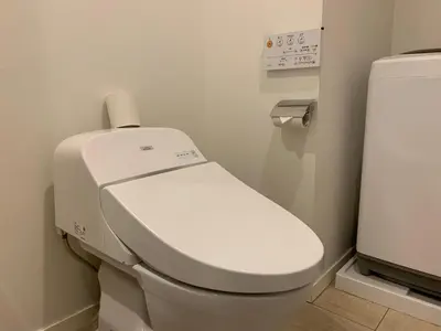 a bathroom with a toilet with a roll of toilet paper on it at SALON\u6e0b\u8c374A in Tokyo