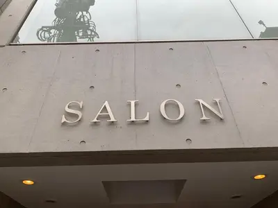a sign on the top of a building at SALON\u6e0b\u8c374A in Tokyo