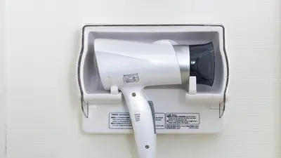 a toilet paper dispenser hanging on a wall at Toyoko Inn Tokyo Otemachi in Tokyo