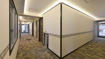 a hallway with a large white wall at Toyoko Inn Tokyo Otemachi in Tokyo