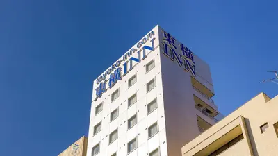 a tall white building with blue letters on it at Toyoko Inn Tokyo Otemachi in Tokyo