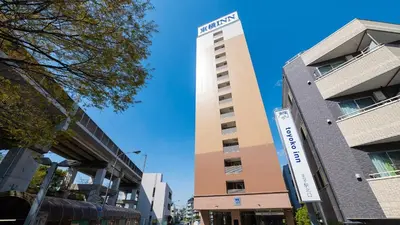 a tall building with a sign on the side of it at Toyoko Inn Tokyo Keihin Tohoku sen Oji eki Kita guchi in Tokyo