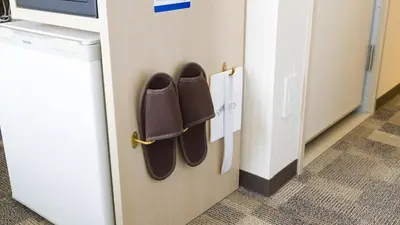 a pair of shoes are hanging on a door at Toyoko Inn Tokyo Keihin Tohoku sen Oji eki Kita guchi in Tokyo
