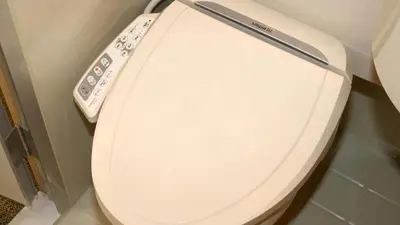 a toilet with a remote control on the side of it at Toyoko Inn Tokyo Keihin Tohoku sen Oji eki Kita guchi in Tokyo
