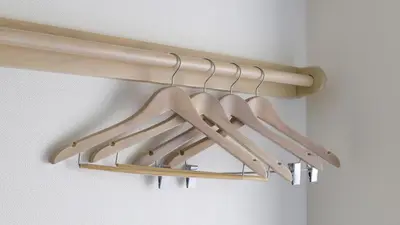 a bunch of wooden hangers hanging from a wall at Toyoko Inn Omori in Tokyo