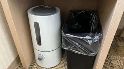 a white appliance sitting next to a trash can at Toyoko Inn Omori in Tokyo