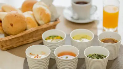 a table with cups of soup and a basket of bread at Toyoko Inn Omori in Tokyo