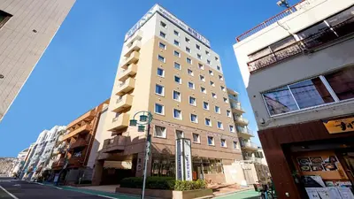 a tall white building on a city street at Toyoko Inn Tokyo Shinagawa Hatanodai eki Minami guchi in Tokyo