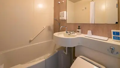 a bathroom with a sink and a toilet at Toyoko Inn Tokyo Nihombashi Zeimusho Mae in Tokyo