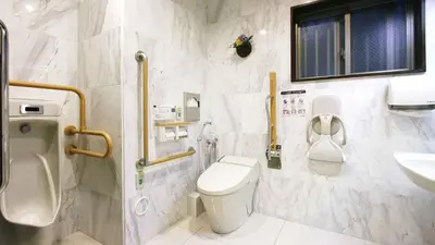a white bathroom with a toilet and a sink at Toyoko Inn Tokyo Nihombashi Zeimusho Mae in Tokyo