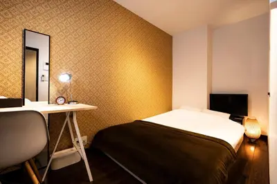 a bedroom with a bed and a desk and a mirror at Apartment Sun Bright - Vacation STAY 89260v in Tokyo