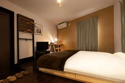 a bedroom with a large white bed and a television at Apartment Sun Bright - Vacation STAY 89260v in Tokyo
