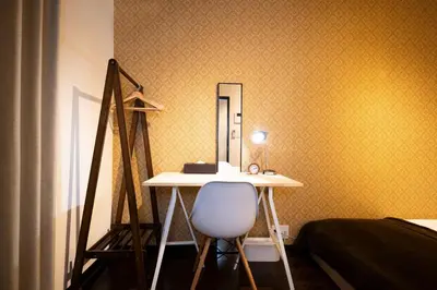 a room with a desk and a mirror and a bed at Apartment Sun Bright - Vacation STAY 89260v in Tokyo