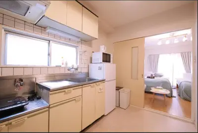 a kitchen with a sink and a refrigerator at Tokyo Stay Excel Shinjuku in Tokyo