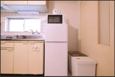 a white refrigerator with a microwave on top of it at Tokyo Stay Excel Shinjuku in Tokyo