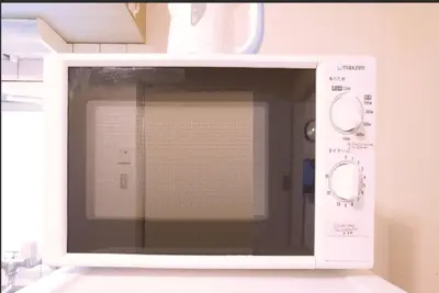 a white microwave oven sitting on top of a counter at Tokyo Stay Excel Shinjuku in Tokyo