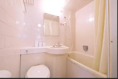 a bathroom with a toilet and a sink and a tub at Tokyo Stay Excel Shinjuku in Tokyo