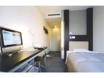 a hotel room with a bed and a desk with a computer at R&B Hotel Tokyo Toyocho - Vacation STAY 40490v in Tokyo