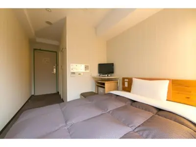 a bedroom with a large bed and a desk at R&B HOTEL HIGASHI NIHONBASHI - Vacation STAY 40468v in Tokyo