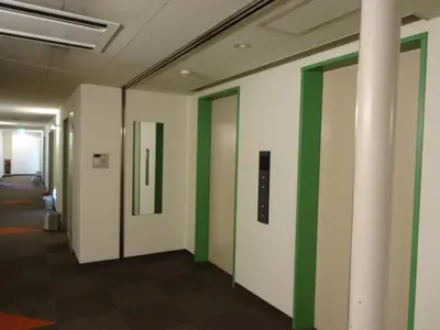 a corridor of an office with green and white walls at R&B HOTEL HIGASHI NIHONBASHI - Vacation STAY 40472v in Tokyo