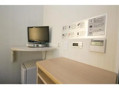 a room with a desk with a tv on a wall at R&B HOTEL HIGASHI NIHONBASHI - Vacation STAY 40472v in Tokyo