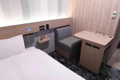 a small room with a bed and a desk and a sink at R&B Hotel Otsuka Eki Kitaguchi - Vacation STAY 40485v in Tokyo
