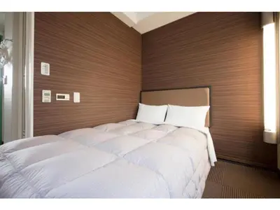 a bedroom with two beds in a room at R&B Hotel Otsuka Eki Kitaguchi - Vacation STAY 40487v in Tokyo