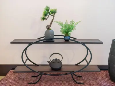 a coffee table with two vases and a plant on it at YADOYA Ryusenjicho in Tokyo