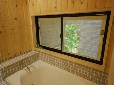 a bath tub in a bathroom with a window at YADOYA Ryusenjicho in Tokyo