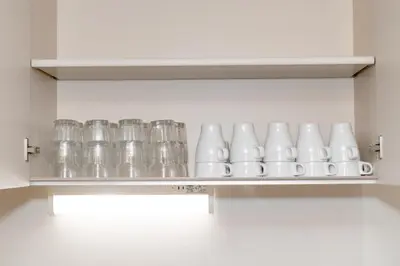 a row of glasses on a shelf in a kitchen at The Felice Uguisudani - Vacation STAY 96241 in Tokyo