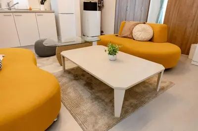 a living room with a yellow couch and a table at The Felice Uguisudani - Vacation STAY 96241 in Tokyo