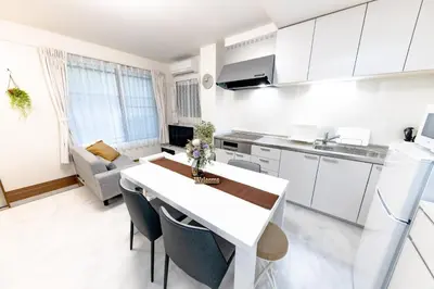 a kitchen and living room with a table and a couch at The Felice Uguisudani - Vacation STAY 96242 in Tokyo