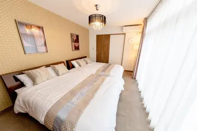 two large beds in a room with a window at The Felice Uguisudani - Vacation STAY 96242 in Tokyo