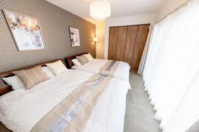 a bedroom with two beds and a window at The Felice Uguisudani - Vacation STAY 96242 in Tokyo
