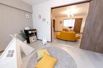 a living room with a yellow couch and a mirror at The Felice Uguisudani - Vacation STAY 96242 in Tokyo