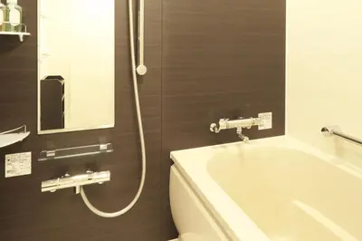 a bathroom with a tub and a toilet and a sink at Centurion Hotel Grand Akasakamitsuke Station in Tokyo