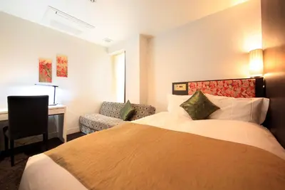a hotel room with a bed and a desk at Centurion Hotel Grand Akasakamitsuke Station in Tokyo
