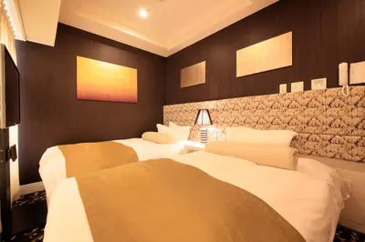 two beds in a room with black walls at Centurion Hotel Grand Akasakamitsuke Station in Tokyo
