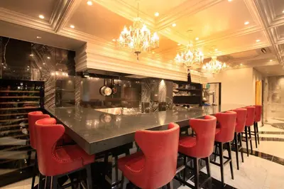 a bar with red bar stools in a wine cellar at Centurion Hotel Grand Akasakamitsuke Station in Tokyo