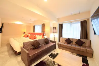 a hotel room with a bed and a couch at Centurion Hotel Grand Akasakamitsuke Station in Tokyo